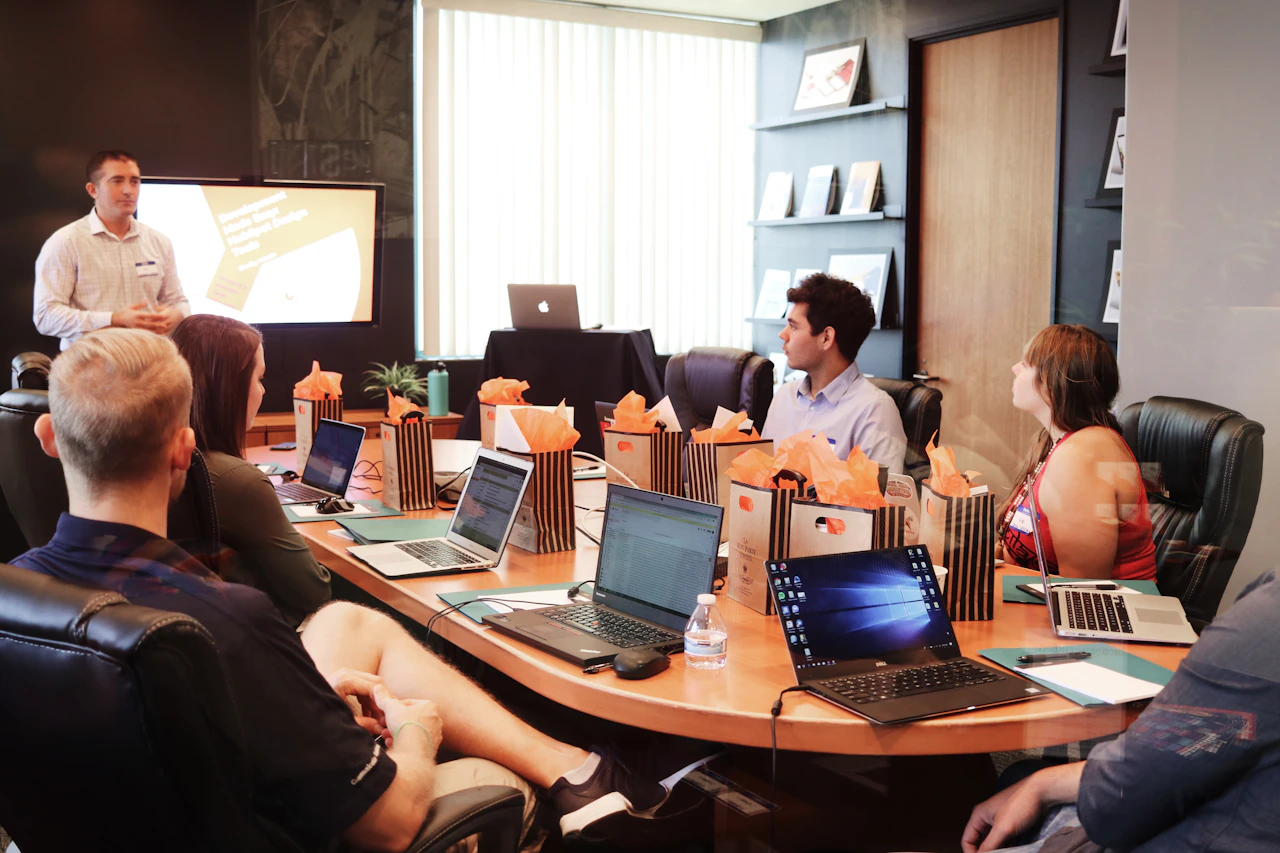 Business professionals discussing a presentation around a meeting table